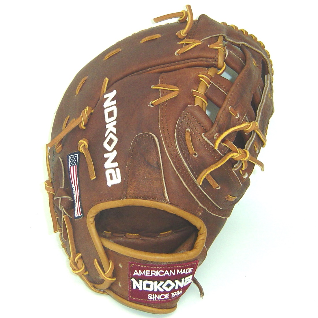 he Nokona Walnut W-N70 12.5 inch First Base Glove is inspired by Nokona’s history of excellence and handcrafting gloves in America for 80 years. If you have been making gloves for 80 plus years, then you know how to make a reliable piece of leather. This is what you get from the Nokona brand. They provide players with classic gloves that they can rely on game in and game out, and season in and season out. When you purchase a first baseman’s glove, it simply must be an excellent piece of leather. This is what you get with the Nokona Walnut W-N70 13 inch First Base Glove. So, just know when you buy from Nokona, it is going to be extremely high quality. The reason that this glove is so great is because of the leather Nokona uses to make it. They use Walnut Crunch leather which is a signature of Nokona. This leather gives players excellent stability, and durability which is great to have at first base. First basemen need to be calm, cool, and collect in order to catch everything. So, what would help you be calm, cool, and collect at first base A stable glove will be able to keep you calm in order to be your best at first best. This series of glove is updated in order to highlight the glove’s modern features, but it also keeps to the Nokona’s roots. This is the great because it pays tribute to their baseball and softball heritage.