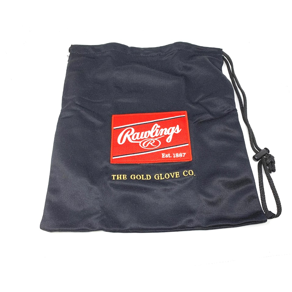 The Rawlings Cloth Glove Bag with Rawlings logo and drawstring closure is the perfect accessory for any baseball player looking to protect and transport their gloves. Made from high-quality cloth material, this bag is durable and designed to keep your gloves in pristine condition. The Rawlings logo prominently displayed on the front adds a touch of style and brand recognition. The drawstring closure allows for easy access and secure transport, making it the ideal choice for players on the go. Whether you are headed to the field or simply storing your gloves at home, the Rawlings Cloth Glove Bag is a must-have for any baseball player looking to keep their Rawlings gloves in top shape.